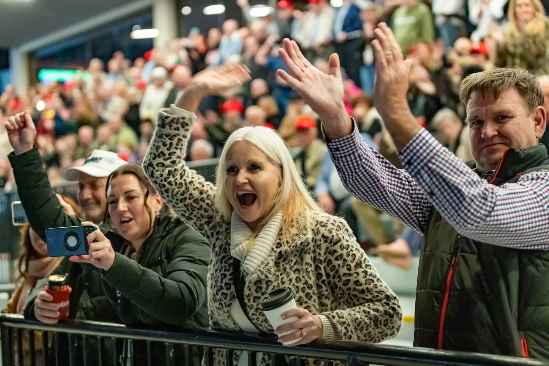 Excited spectators cheering beside the track at The Creek