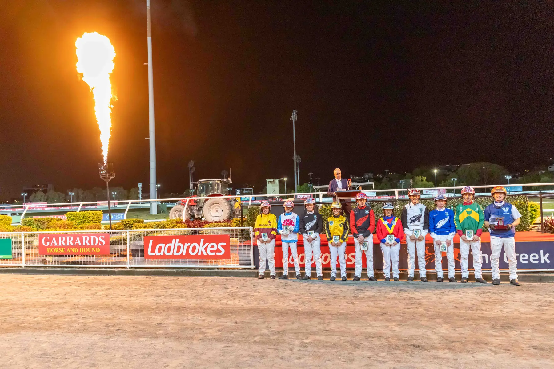 Inter Dominion drivers assembled beside a flame display at The Creek