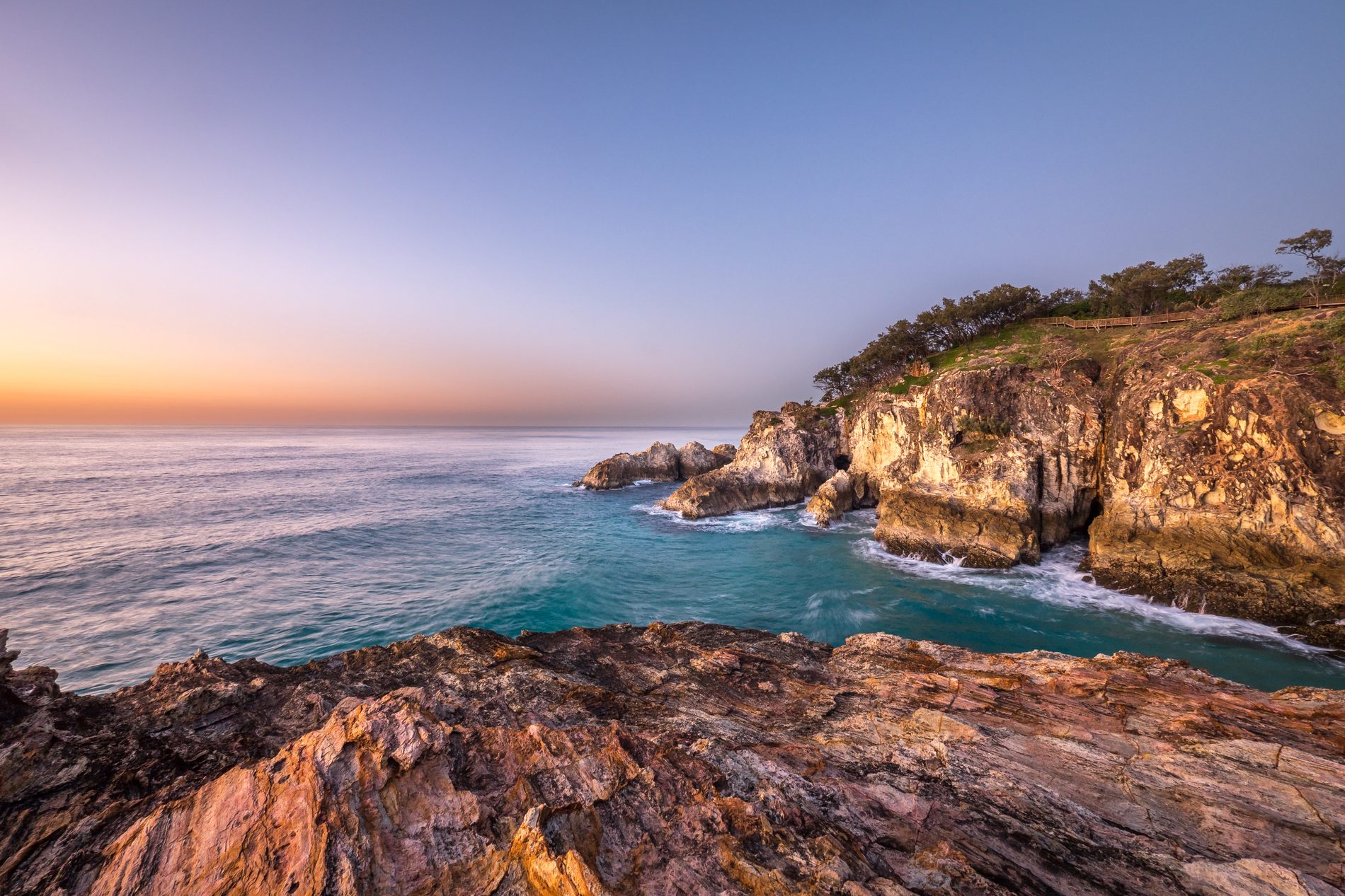 Rocky Queensland coastline and ocean at twilight